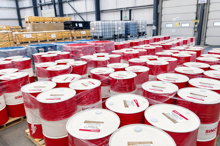 Red and white barrels with Sinopec branding in a warehouse setting